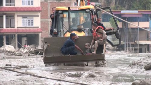 Lực lượng cứu hộ đưa người bị thương ra khỏi khu vực lở đất.