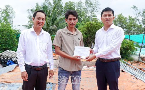 Lãnh đạo Đảng uỷ, HĐND, UBND, UB MTTQ Việt Nam xã Đất Mũi trao tiền hỗ trợ gia đình ông Phan Chí Tâm khắc phục khó khăn trước mắt.