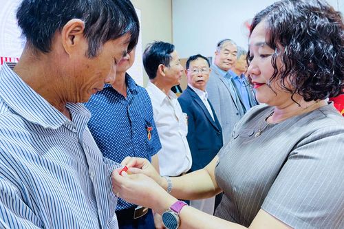 Đồng chí Đinh Thị Thu Thủy, Phó Bí thư Đảng ủy, Chủ tịch UBND xã trao Huy hiệu Đảng cho các đảng viên
