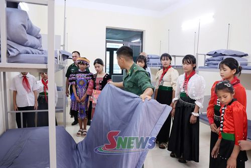 Cán bộ, chiến sĩ Đồn biên phòng Chiềng On hướng dẫn học sinh Trường Phổ thông nội trú Tiểu học - THCS Yên Sơn sinh hoạt nội trú.