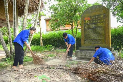 Đoàn viên thanh niên tham gia dọn dẹp, vệ sinh Di tích lịch sử quốc gia đặc biệt nhà cụ Vi Văn Khang. Ảnh: Nguyễn Cường