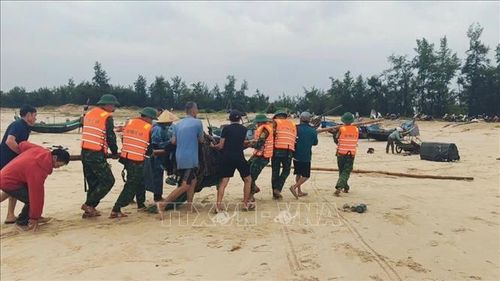 Đồn Biên phòng Cửa khẩu cảng Cửa Việt chủ trì phối hợp với chính quyền địa phương, các lực lượng chức năng có liên quan và người dân triển khai nhân lực và phương tiện kéo ghe đánh cá và ngư lưới cụ. Ảnh: TTXVN phát