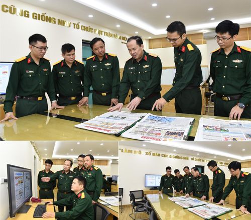 Thiếu tướng Đoàn Xuân Bộ, Bí thư Đảng ủy, Tổng biên tập Báo Quân đội nhân dân trao đổi với cán bộ, biên tập viên Phòng Thư ký tòa soạn thực hiện một số báo. Ảnh: qdnd.vn