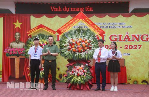 Trung tá Trần Cường, Phó Cục trưởng Cục Hậu cần (Bộ Công an) tặng hoa chúc mừng nhà trường. Ảnh: Nguyễn Lựu