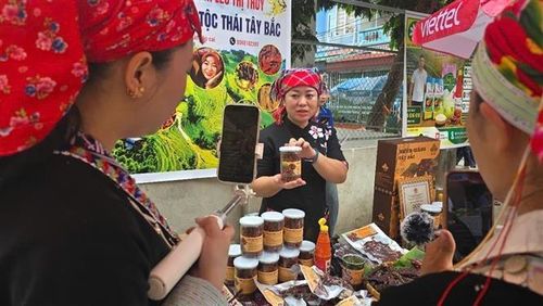 Các hộ kinh doanh tại Bát Xát bán hàng trên nền tảng số. Ảnh: Hương Thu - TTXVN