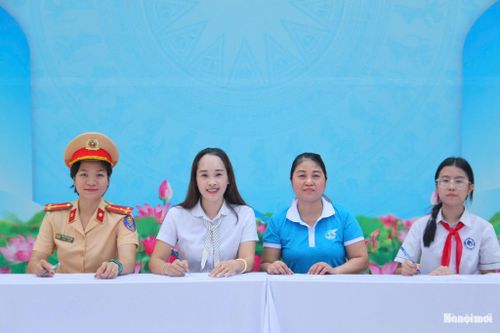 Đại diện Công an phường Phú Thượng, Trường TH&THCS Phú Thượng, Hội LHPN phường và học sinh ký cam kết chấp hành các quy định về trật tự, an toàn giao thông. Ảnh: Cao Kỳ
