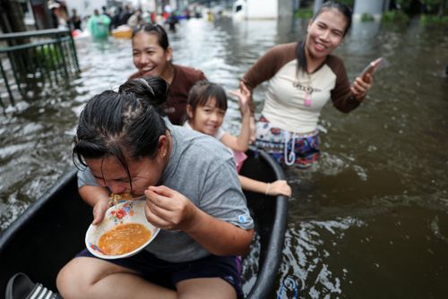 Người dân mua rau củ tại một khu chợ ngập lụt ở Bangkok (Thái Lan) ngày 28/9. Ảnh: Reuters.