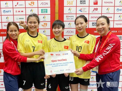 HLV trưởng Trần Thị Vui (ngoài cùng, bên trái) và HLV phó Hoàng Thái Xuân (ngoài cùng, bên phải), cùng các VĐV nội dung đôi nữ môn cầu mây nhận thưởng sau thành tích giành huy chương vàng. Ảnh: BÙI LƯỢNG