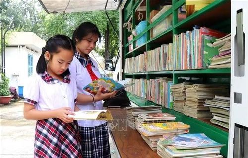 Học sinh tham quan, đọc sách tại buổi lễ.