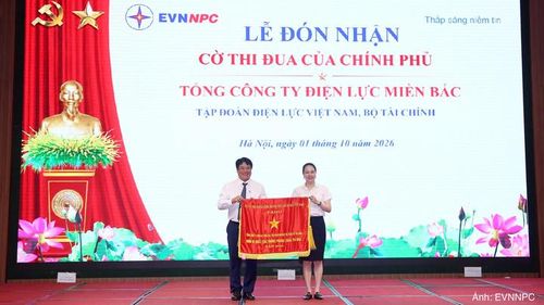 Thừa ủy quyền của Thủ tướng Chính phủ, ông Nguyễn Anh Tuấn trao Cờ Thi đua cho bà Đỗ Nguyệt Ánh, Bí thư Đảng ủy, Chủ tịch HĐTV EVNNPC, đại diện Tổng công ty đón nhận.