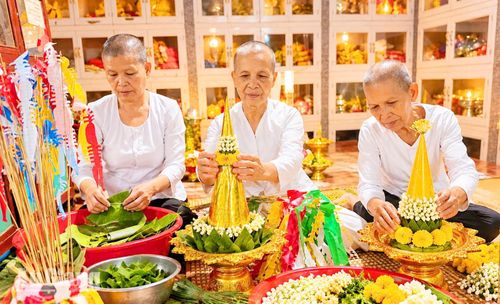 Các thành viên ban nghi lễ chùa Xẻo Cạn, xã Vĩnh Hòa chuẩn bị lễ vật, hoa và bánh trái cho nghi thức Sene Đôn Ta, thể hiện lòng thành kính với ông bà, tổ tiên. Ảnh: DANH THÀNH
