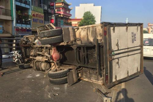 Xe tải tông xe máy lật ngang trên cầu, 4 người bị thương