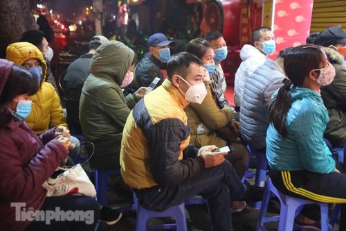 Người dân đội mưa giữa đêm, bịt khẩu trang chờ mua vàng ngày vía Thần Tài