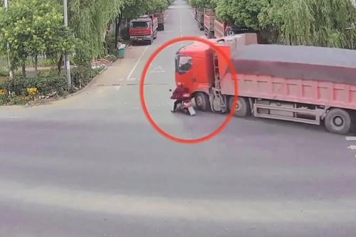 Bị xe tải đổ đè lên người, người phụ nữ thoát chết nhờ mũ bảo hiểm