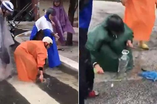 Người dân Đà Nẵng rủ nhau mặc áo mưa ra đường... bắt cá: 'Lạc quan giữa mùa mưa lũ là đây chứ đâu!'