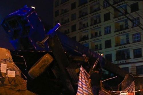 Xe ô tô cần cẩu đổ nghiêng vào chung cư, một công nhân bị vùi lấp