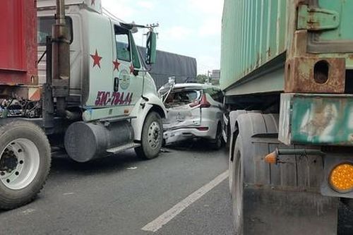Hai xe container 'ép' một xe 7 chỗ bẹp dúm ở Sài Gòn