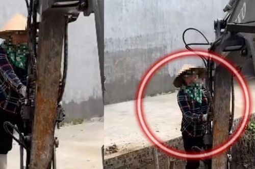 Người phụ nữ đứng cheo veo trên gầu máy xúc cùng tiếng kêu thất thanh khiến ai nấy xem xong đều rùng mình