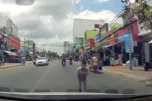 Cậu bé khoanh tay, cúi đầu cảm ơn khi được tài xế dừng xe nhường đường