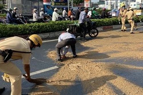Dầu đổ tràn đường, CSGT đổ cát giúp người dân không bị trượt ngã