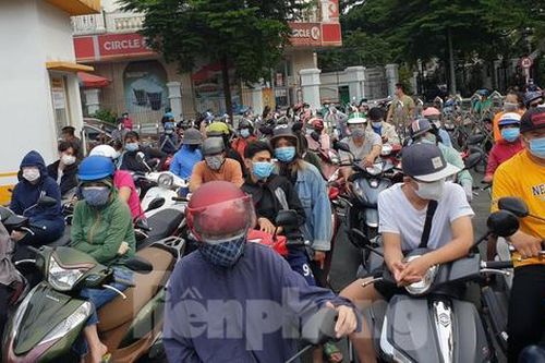 Người dân TPHCM đội mưa xếp hàng dài đợi vào siêu thị ngày giãn cách