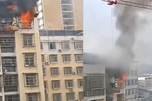 Công nhân dùng cần cẩu tháp cứu cậu bé bị kẹt trong căn hộ bốc cháy