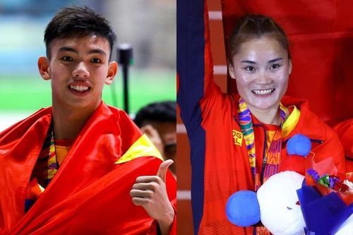 Nguyễn Huy Hoàng và Quách Thị Lan cầm cờ Đoàn Việt Nam tại Olympic