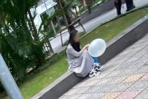Hình ảnh cô gái ngồi một mình hút bóng trên vỉa hè ngày 20/10 khiến MXH xôn xao