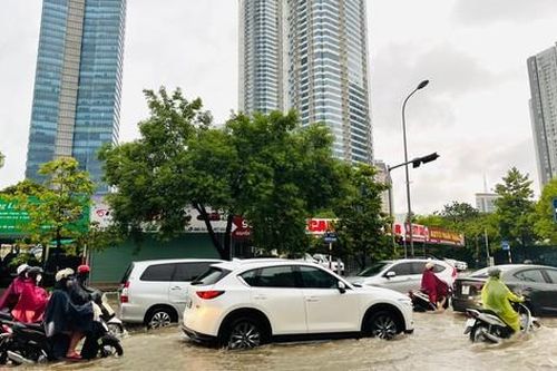 Hà Nội mưa lớn không ngớt, người dân lội nước đi làm