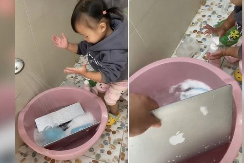 Bé gái xối nước rửa máy tính cho bố