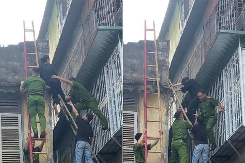 Cô gái trẻ có biểu hiện bất thường, ngồi ở lan can nhà cao tầng sự thật phía sau