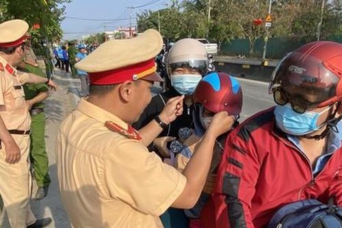 TPHCM: Công an tặng mũ bảo hiểm, nước suối cho người dân về quê đón Tết