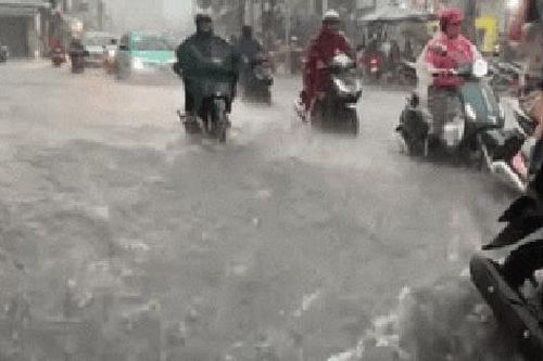 TPHCM: Mưa ngập, người dân chật vật di chuyển giữa dòng nước chảy xiết