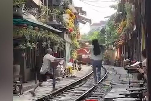 'Thót tim' cảnh nữ du khách lao ra đường ray khi tàu hỏa gần tiến đến ở Hà Nội