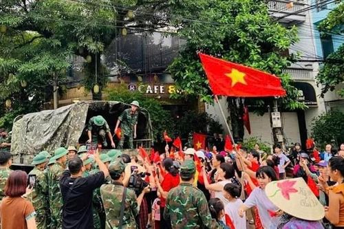 Xúc động hình ảnh người dân mang cờ, hoa chào tạm biệt các chú bộ đội