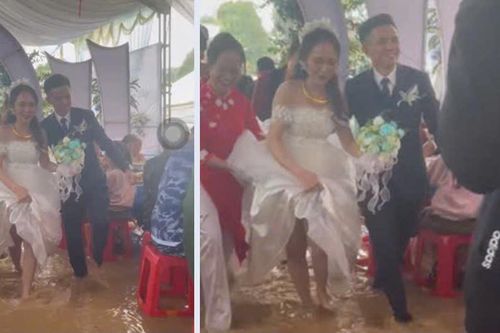 Cô dâu chú rể bì bõm lội nước tiếp khách trong nước lũ