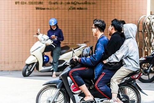 Nhiều học sinh, sinh viên 'đầu trần, kẹp ba' lao vun vút trên đường phố Hà Nội
