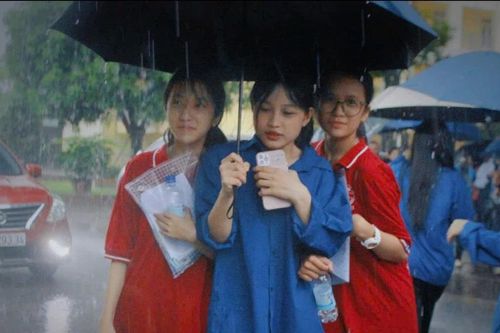 Tình nguyện viên đội mưa hỗ trợ thí sinh lớp 10 tại Hà Tĩnh