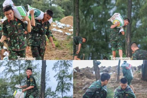 Công an, quân đội 'đội mưa' vác cát leo mái nhà, bê đá kè đê biển khi bão Kajiki sắp đổ bộ