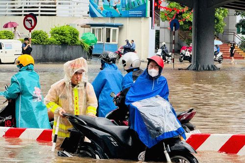 Hà Nội ngập sâu sau trận mưa lớn, lực lượng CSGT dầm mình giúp người dân qua nơi ngập úng