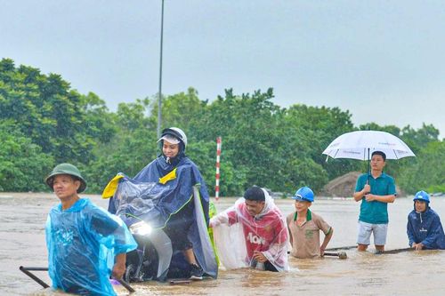 Ùn dài hàng km trên Đại lộ Thăng Long, dịch vụ kéo xe qua khu vực ngập lụt 'đắt khách'