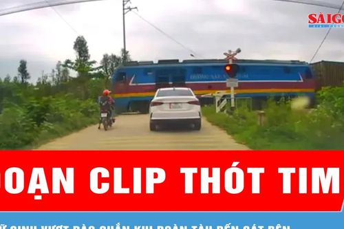 Thót tim cảnh 2 nữ sinh vượt rào chắn đường sắt trước đoàn tàu đang tới