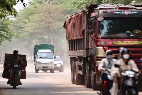 Xe tải 'quần thảo' bụi phủ trắng con phố ở Hà Nội