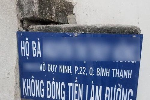 Ai treo biển bêu tên nữ chủ hộ vì 'không đóng tiền làm đường'?