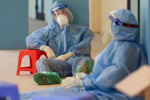 Nhân viên xét nghiệm kiệt sức, ngồi bệt xuống đất sau nhiều giờ truy vết F0