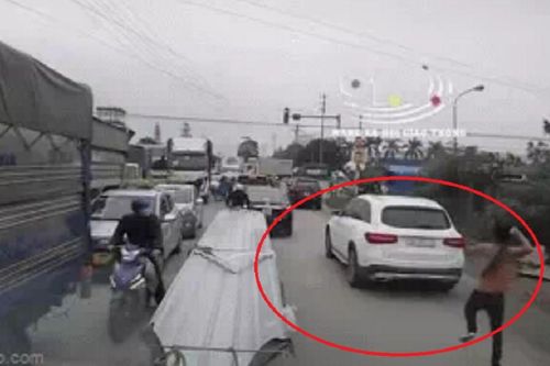 Clip: Gã đàn ông cởi trần cầm gậy vụt mạnh vào kính xe Mercedes đang lưu thông trên đường
