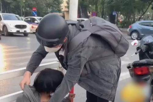 Chàng trai khoác áo ấm cho em nhỏ bán hàng rong