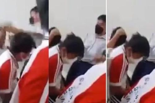 Thầy giáo tát vào đầu, mặt học sinh vì lo sợ các em bị điện giật