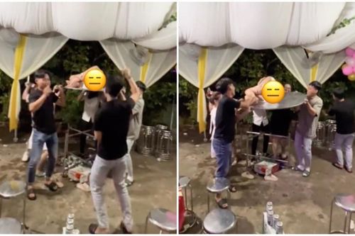 Đi ăn cưới, gái xinh váy ngắn nằm giữa bàn để nam thanh nữ tú khiêng lên nhún nhảy gây tranh cãi
