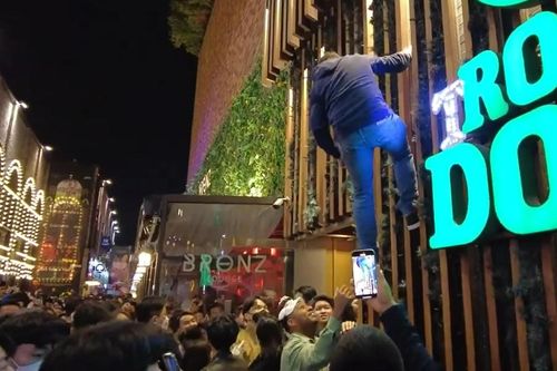 Người đàn ông leo tường tránh đám đông ở Itaewon